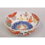 A JAPANESE IMARI PORCELAIN BOWL, painted with figures, the base with character mark, 24cm diameter.