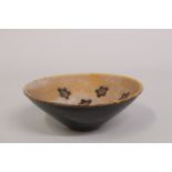 AN UNUSUAL CIZHOU POTTERY BOWL, with flower designs to the interior, 15.5cm diameter.