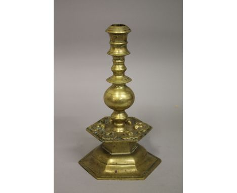 A 17TH-18TH FLEMISH BRASS CANDLESTICK, with cherubs, 28cm high.