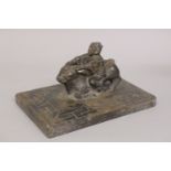 A CHINESE CARVED HARDSTONE FIGURAL GROUP of a man riding an oxen upon a key-carved rectangular base,