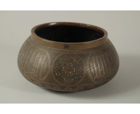 A 19TH CENTURY OR EARLIER PERSIAN ENGRAVED BRASS BOWL, with calligraphy panels, 22cm diameter.