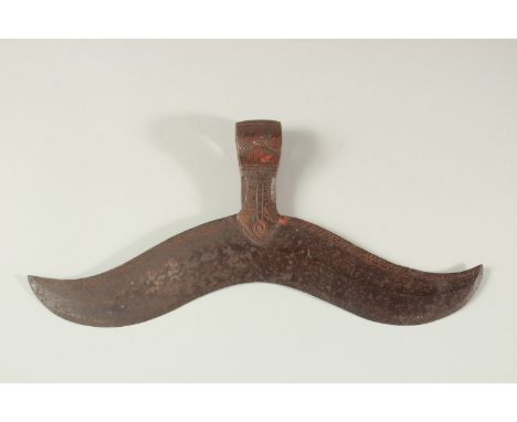 A LARGE 17TH -18TH CENTURY SOUTH INDIAN AXE HEAD, engraved and with traces of red pigment, 32cm long.