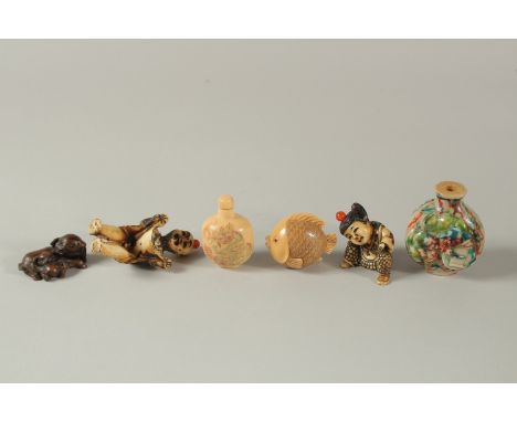 A COLLECTION OF FOUR CHINESE / JAPANESE SNUFF BOTTLES, together with a signed carving of a fish and another carved wood netsu