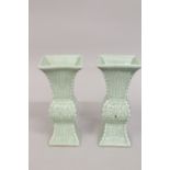 A PAIR OF CHINESE CELADON GLAZED PORCELAIN QUADRANGULAR VASES, with carved archaic style decoration,