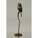 A BRONZE OKIMONO OF A BIRD, raised on a stalk, 17cm high.