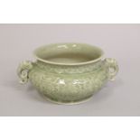 A CHINESE CELADON GLAZE PORCELAIN TWIN HANDLE CENSER BURNER, with carved dragon and phoenix, 21cm