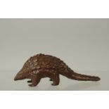 A BRONZE OKIMONO OF A PANGOLIN, 10cm long.