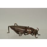 A BRONZE OKIMONO OF A GRASSHOPPER, 8.5cm long.