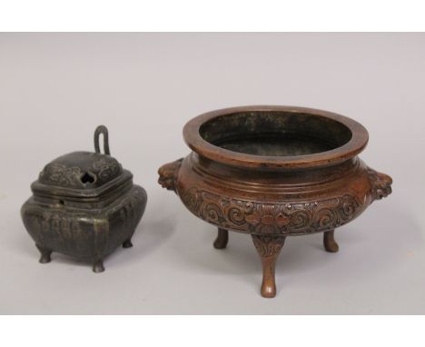 A CHINESE BRONZE TRIPOD CENSER, with foliate designs and lion dog handles, the base with character mark, 20cm wide (handle to