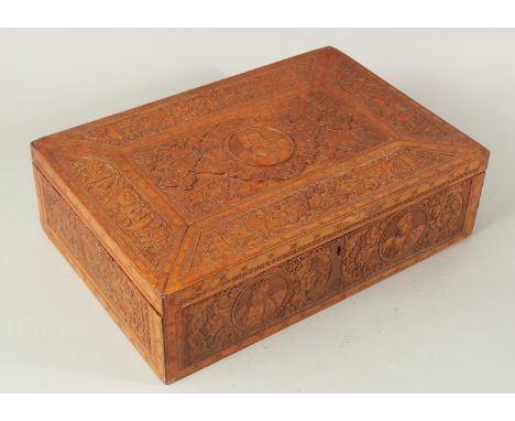 A VERY FINE AND LARGE 19TH CENTURY PERSIAN CARVED WOOD BOX, the hinged lid bearing a central roundel with carved portrait, an