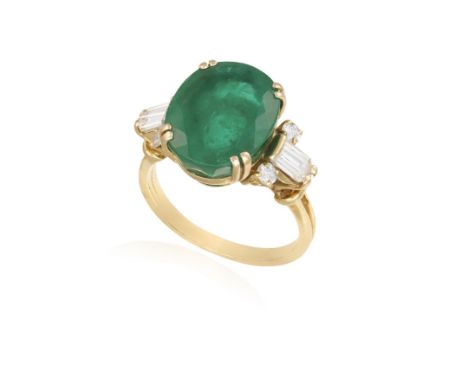 AN EMERALD AND DIAMOND DRESS RINGComposed of a central oval-shaped emerald weighing approximately 4.80cts within a double fou