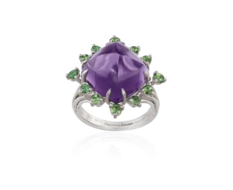 AN AMETHYST AND TSAVORITE COCKTAIL RING, BY MARGHERITA BURGENERCentring a sugarloaf cabochon amethyst weighing 13.98cts withi