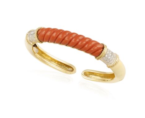 A CORAL AND DIAMOND BANGLEComposed of a central fluted corallium rubrum coral, between single-cut diamonds shoulders with rop