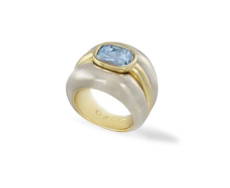 AN AQUAMARINE RINGThe central cushion mixed-cut aquamarine within collet-setting within a gold bi-coloured bombé mount, mount