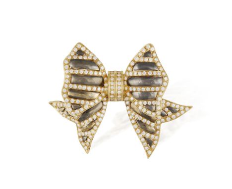 A DIAMOND BOW BROOCH, CIRCA 1990Designed as a stylised polished oxidised gold bow, set with brilliant-cut diamonds in a strip