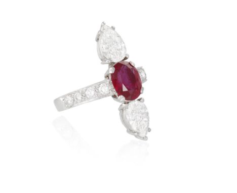 A RUBY AND DIAMOND DRESS RINGComposed of an oval-shaped ruby weighing 2.04cts within a four-claw setting, between two pear-sh