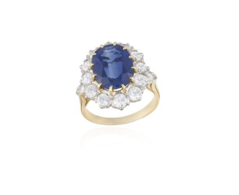 A SAPPHIRE AND DIAMOND CLUSTER RINGThe oval-shaped sapphire weighing approximately 3.50cts within a multiple-claw setting and