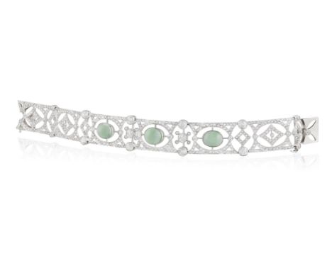 A BELLE EPOQUE JADE AND DIAMOND BRACELET, CIRCA 1910Designed as a series of finely pierced geometric panels, with three oval-