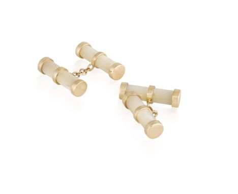 A PAIR OF MOTHER-OF-PEARL CUFFLINKSEach cylinder-shaped terminal set with polished mother-of-pearl, accented with gold caps, 
