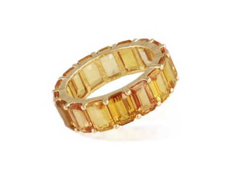 A COLOURED SAPPHIRE RINGComposed of a continuous row of rectangular-cut yellowish-orange sapphires, mounted in 18K gold, ring