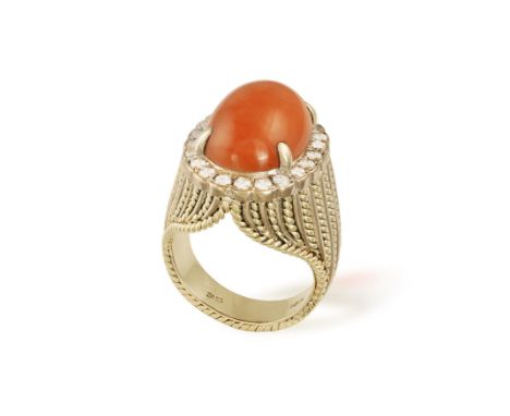 A CORAL AND DIAMOND DRESS RING, CIRCA 1960Of bombé form, set with a central oval-shaped cabochon corallium rumbrum coral, wit