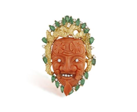 A CORAL, EMERALD AND DIAMOND PENDANTDesigned as a Japanese Noh mask carved in coral with brilliant-cut diamond for eyes and t