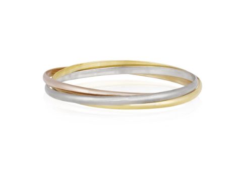 A 'TRINITY' BANGLE, BY CARTIERComposed of three round interlocking tri-coloured bangles, in 18K gold, signed Cartier, numbere