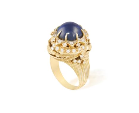 A SAPPHIRE AND DIAMOND COCKTAIL RING, CIRCA 1960Of foliate design, centred with a round-shaped cabochon sapphire within a sta