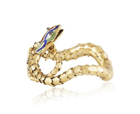 A SAPPHIRE, ENAMEL AND GOLD SERPENT BRACELET, CIRCA 1960Designed as a swirling snake with gold articulated scales, the head d