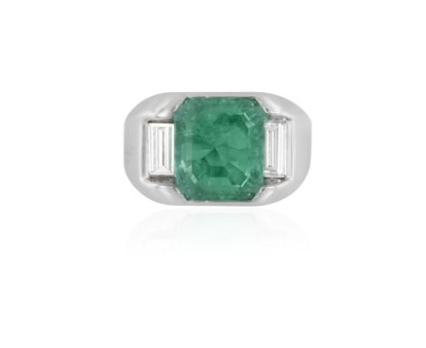 AN EMERALD AND DIAMOND DRESS RINGComposed of a cut-cornered step-cut emerald weighing approximately 4.40cts, between baguette