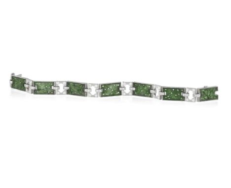 AN ART DECO JADE AND DIAMOND BRACELET, CIRCA 1930Composed of a series of carved jade rectangular plaques set alternately with