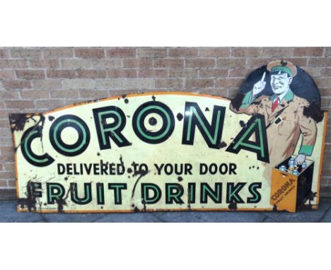 A LARGE CORONA FRUIT DRINKS PICTORIAL ENAMEL WALL SIGN  with a uniformed delivery man carrying a crate, and green and black l