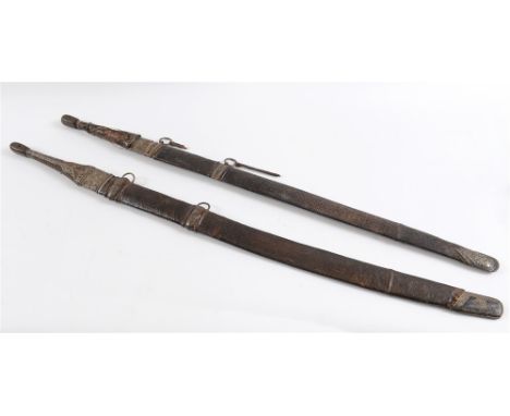 AN OMANI KATTARA (SWORD) the slightly curved blade approximately 77cm long, with a tapering leather-bound and wire-decorated 