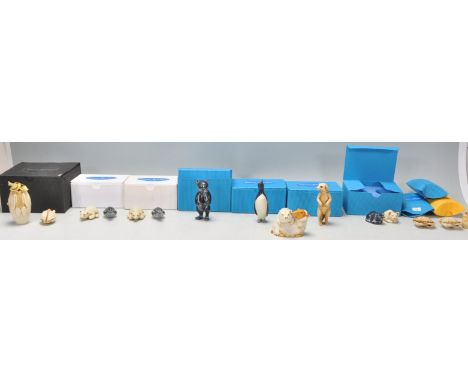 A collection of Adam Binder netsuke style animal figurines to include two polar bears, two penguins, a meerkat, crab, cats et