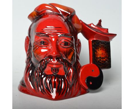 A Royal Doulton ceramic flambe Confucius character jug, having a red glaze. No.D7003, limited edition no. 1238, with certific