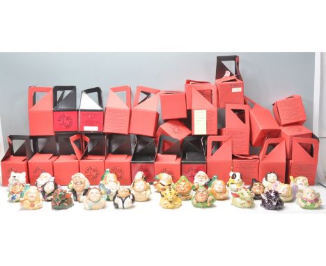 A group of twenty seven Kevin Francis ceramic face pots in the form of various mythical characters to include dragons, santa,
