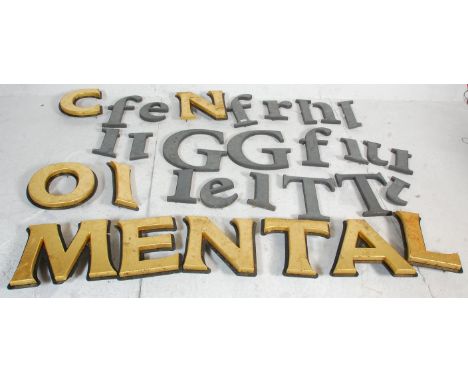 A collection of vintage wooden shop advertising wall mounting cut out letters most being a black finish, also includes some g