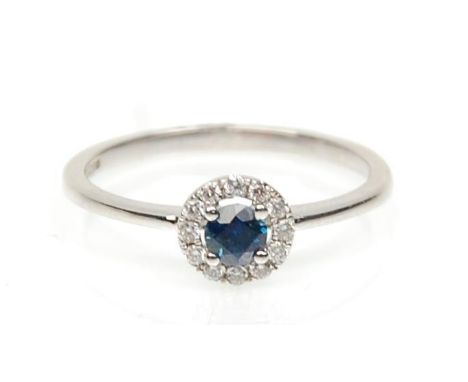 A stamped 18ct white gold ring set with a round cut sapphire and a halo of diamonds. Weight 1.8g. Size L.