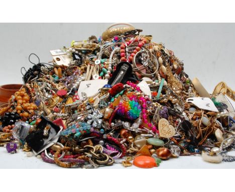 A large collection of vintage and later costume jewellery to include multiple necklace with gold and silver tone examples, be