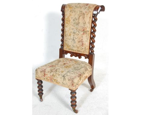 A 19th Century Victorian antique rosewood prie-dieu prayer chair having turned bobbin legs terminating in ceramic castors wit