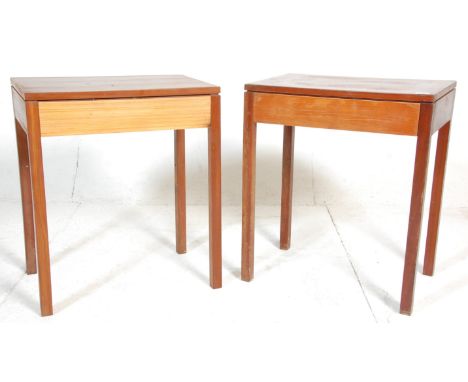 A pair of 1960's Air Ministry type solid teak wood side / lamp tables. Each raised on square tapering legs with fitted frieze