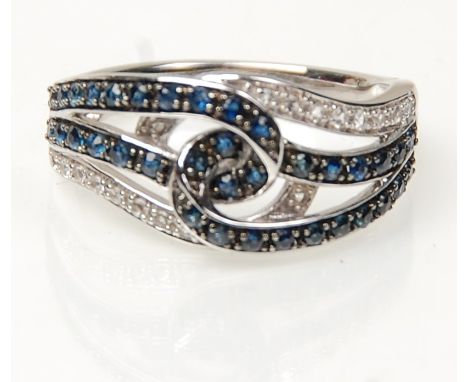 A stamped 14ct white gold knot ring set with diamonds and sapphires. Weight 3.8g. Size L.&nbsp;