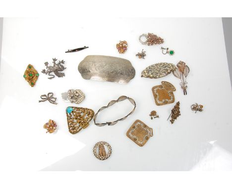 A collection of vintage 20th century fashion jewellery brooches and belt buckles to include a filigree floral brooch, a large