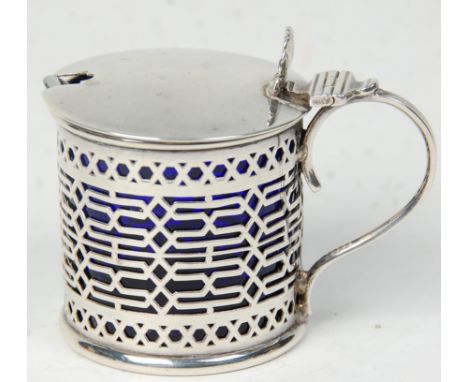 A decorative 19th Century Victorian silver hallmarked mustard pot having fret pierced decoration with plane cover atop on a s
