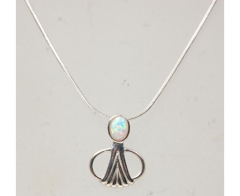 A stamped sterling silver pendant necklace having a snake chain with a Art Nouveau style pendant set with an oval opal panel.