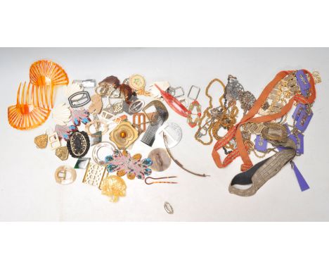 A collection of vintage 20th Century mixed belt buckles to include early plastic examples, mother of pearl, a beaded floral e