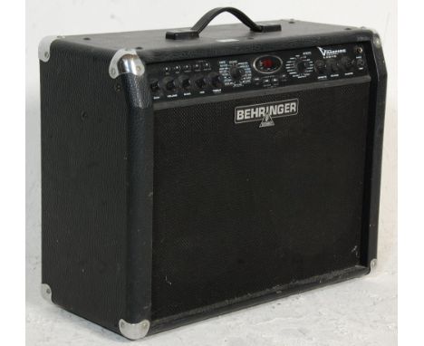 A Behringer V-ampire LX210 electric guitar amplifier having a digital display window, leather finish and carry handle to top.