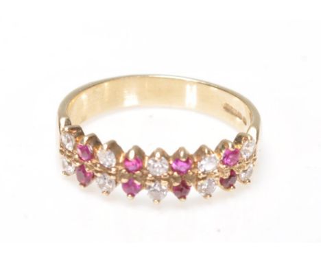 A 9ct gold ruby and diamond 18 stone ring. The ring with prong mounted rows of rubies and diamonds. Total weight 2.6g / Size 