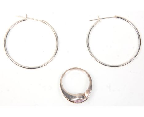 A pair of stamped 925 silver hoop earrings together with a silver cross over design ring set with a round cut pink stone. Wei