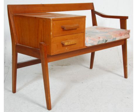 A vintage retro mid 20th Century telephone seat having a bench seat raised on square supports with a two drawer cabinet, comp